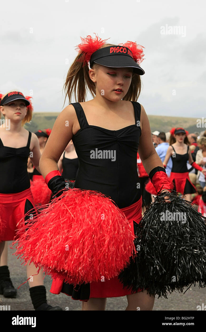 Teenage girls shaking their pom-poms in a carnival parade England Stock - Alamy