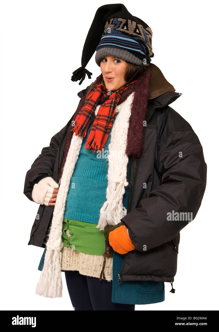 Happy young woman feeling hot under her multi-layers of clothing Stock Photo