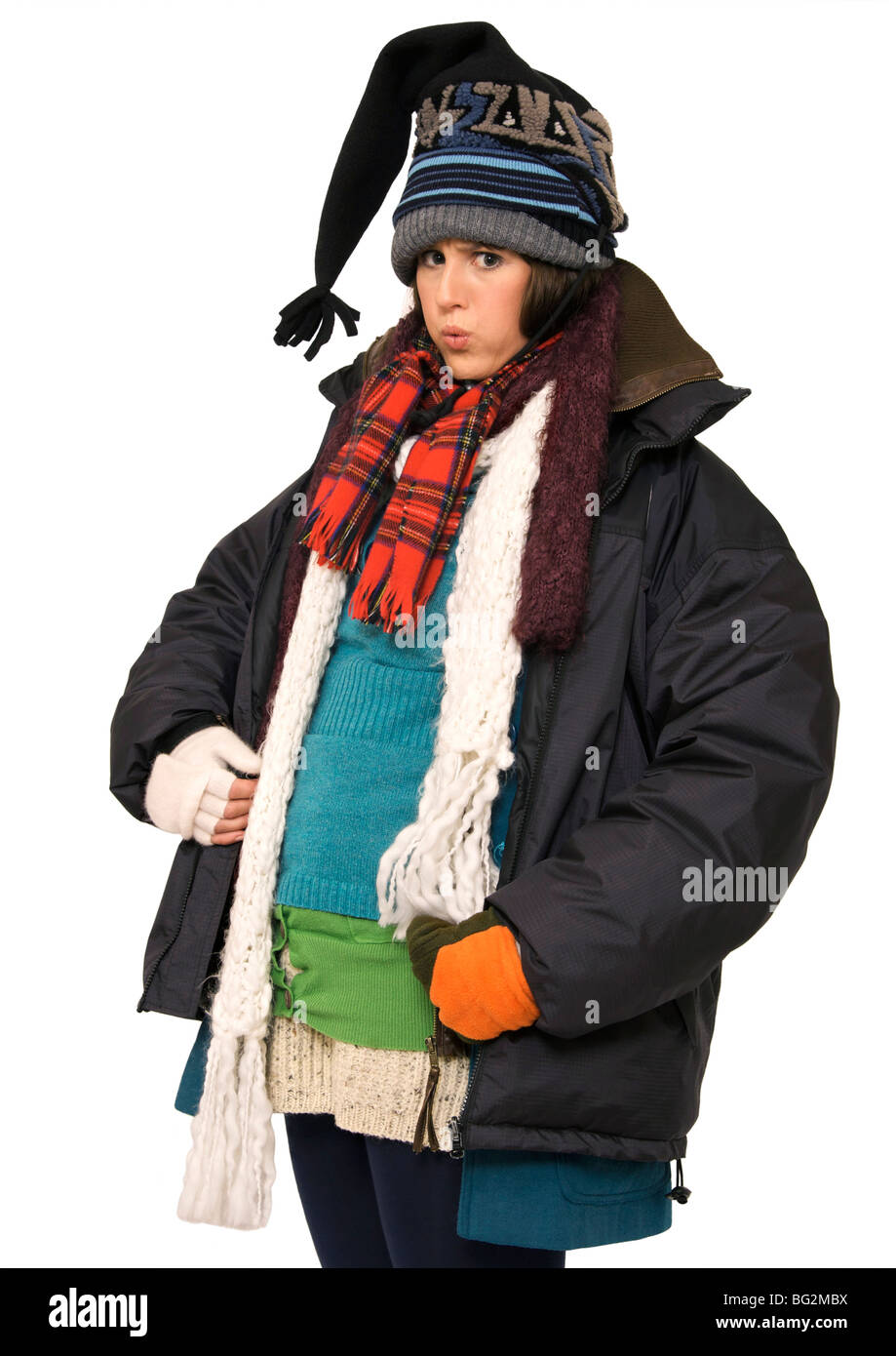 Young woman feeling hot under her multi-layers of clothing Stock Photo
