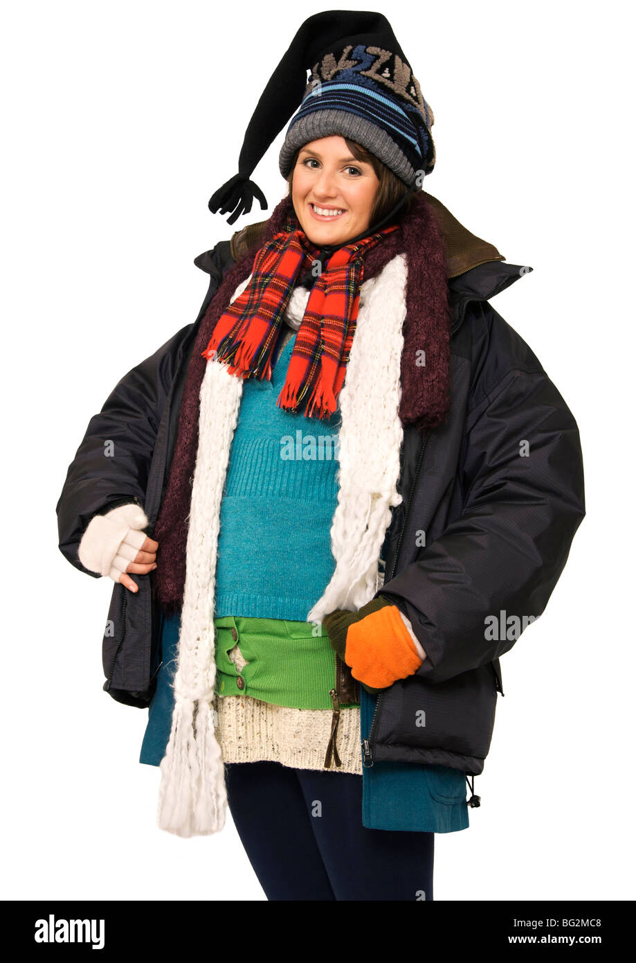 Happy young woman wearing multi-layers of clothing to keep warm Stock Photo