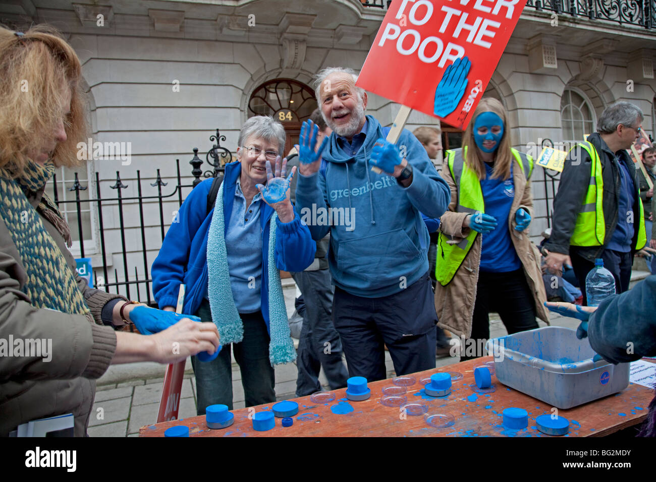Campaigners with blue hands and placards on The Wave Climate Change March London December 5 2009 Stock Photo