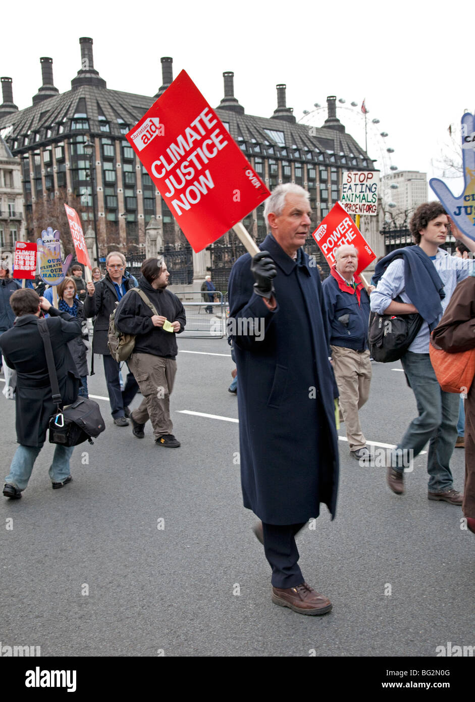 Christian Aid marcher with red banner The Wave Climate Change March London December 5 2009 Stock Photo