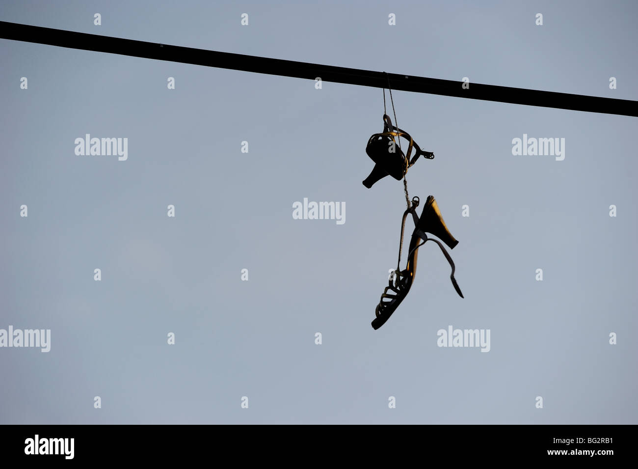 Shoes hanging from power line Stock Photo Alamy