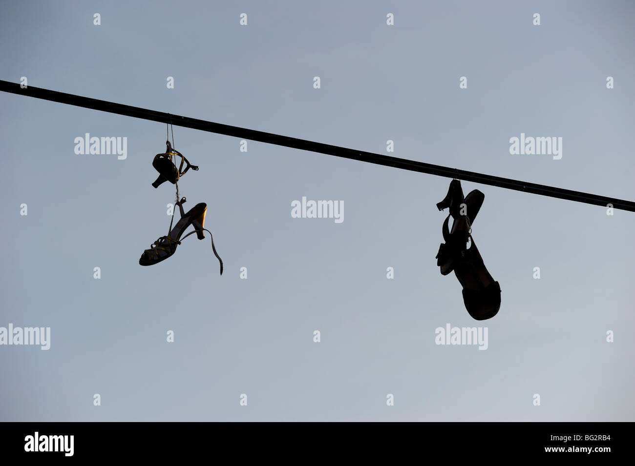 Shoes hanging from power line Stock Photo Alamy