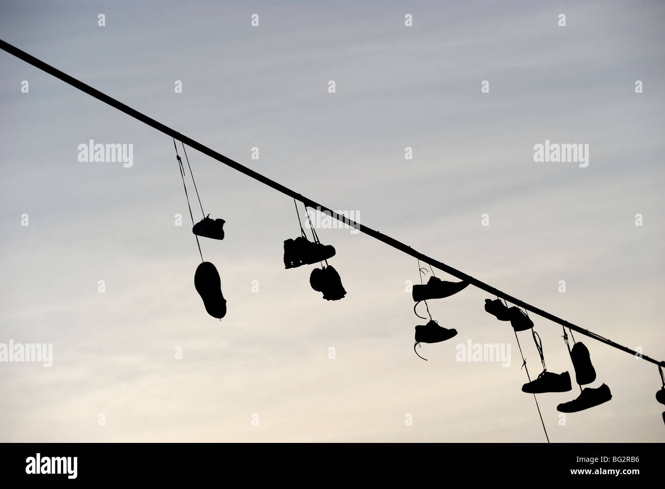 Shoes hanging from power line Stock Photo Alamy