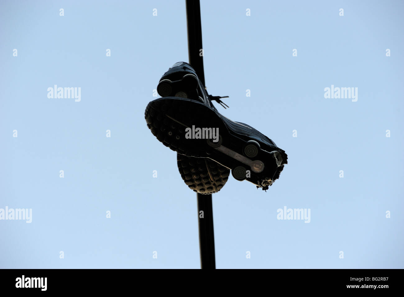 Shoes hanging from power line Stock Photo Alamy