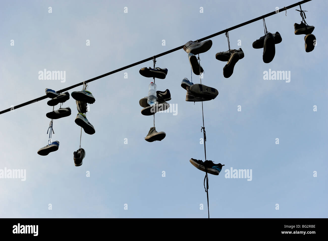 Shoes hanging from power line Stock Photo Alamy