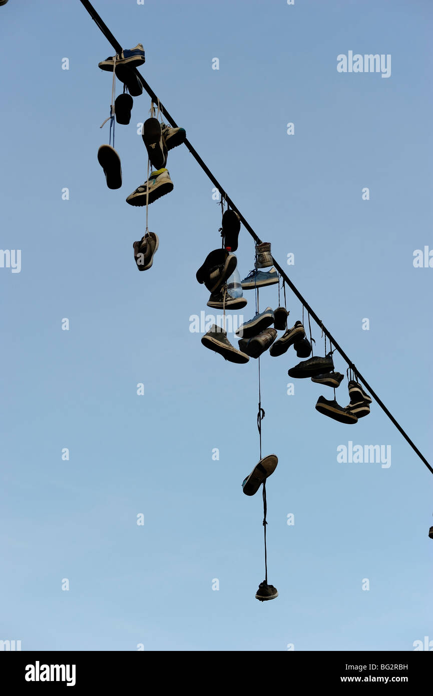 Shoes hanging from power line Stock Photo Alamy