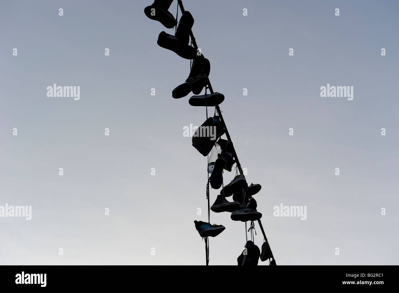 Shoes hanging from power line Stock Photo Alamy