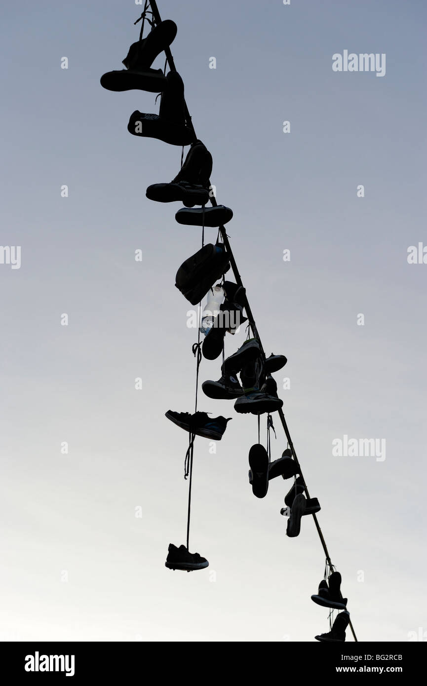 Shoes hanging from power line Stock Photo Alamy