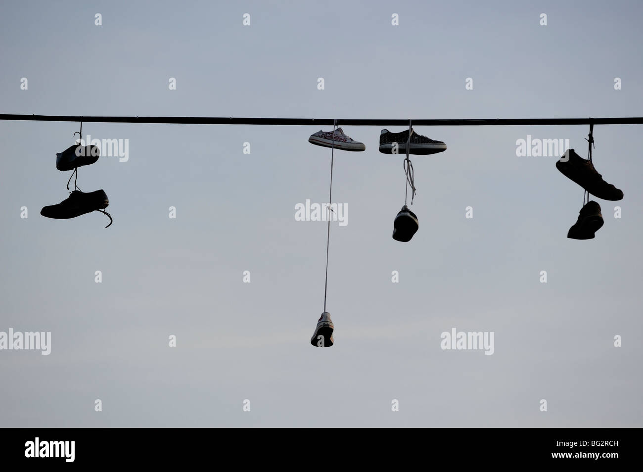 Shoes hanging from power line Stock Photo Alamy