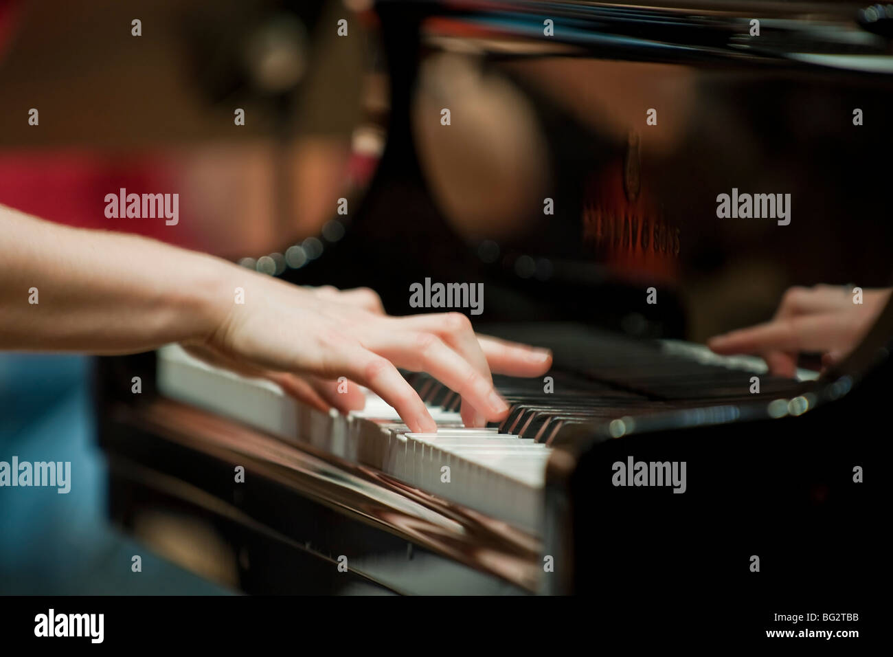 Hands on the keyboard, pianist playing grand piano Stock Photo