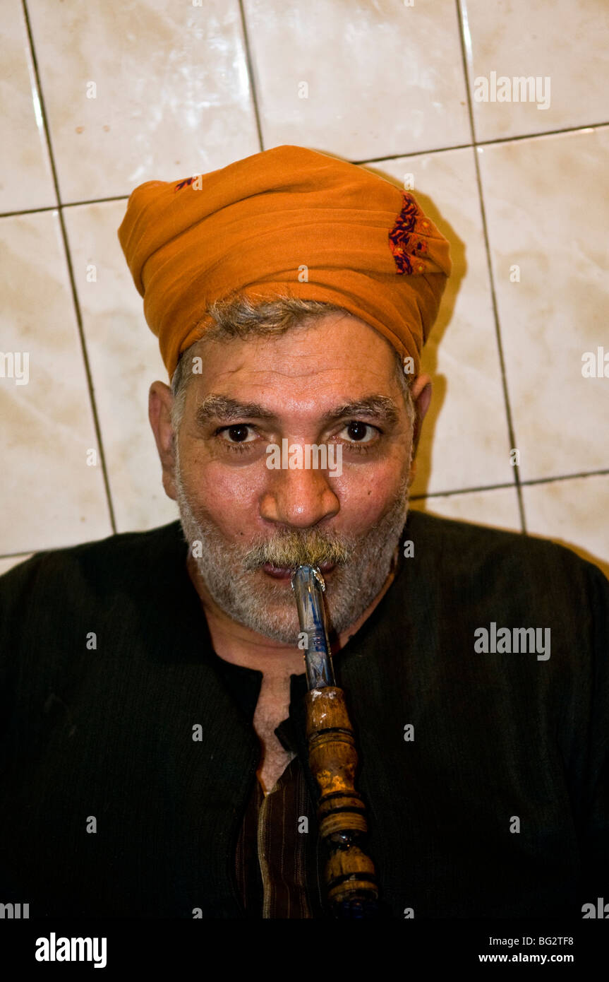 Smoking his Shisha in a small tea house in Cairo. Stock Photo