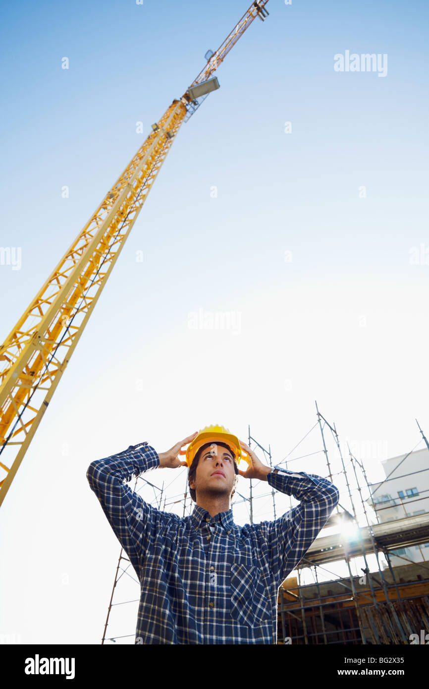 construction worker wearing hard hat. Low angle view, copy space Stock Photo