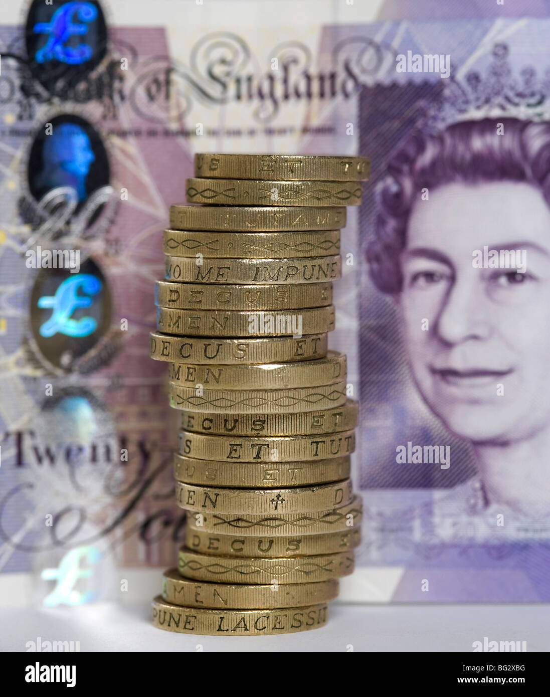 Pounds coins in front of £20 note Stock Photo