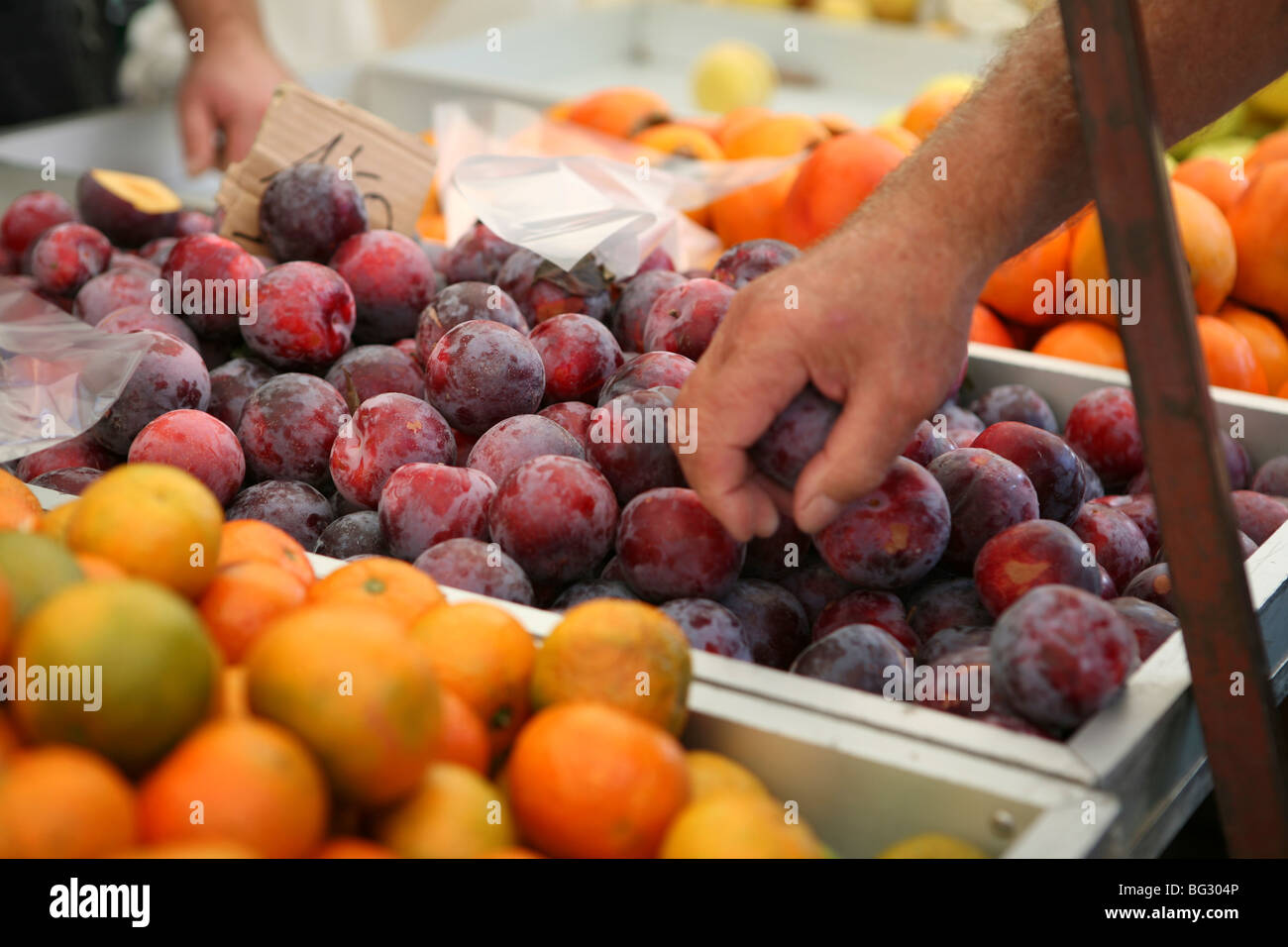 Ripe red plums for sale at a Spanish market, San Pedro Del Pinatar Stock Photo