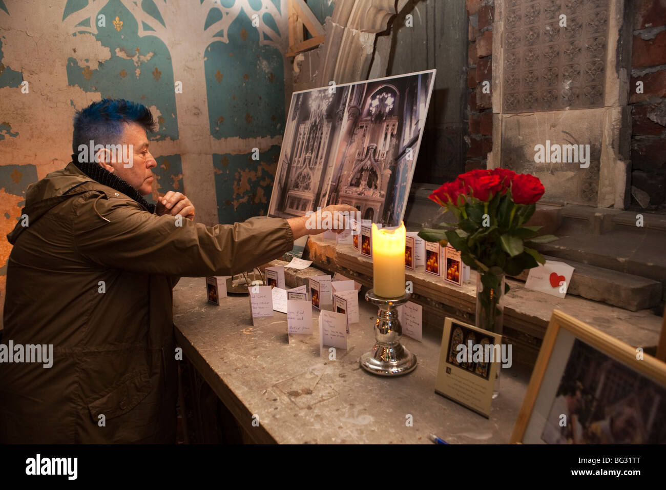 UK, England, Manchester, Gorton Monastery, Church and Friary of Saint Francis, man reading prayer cards on altar Stock Photo