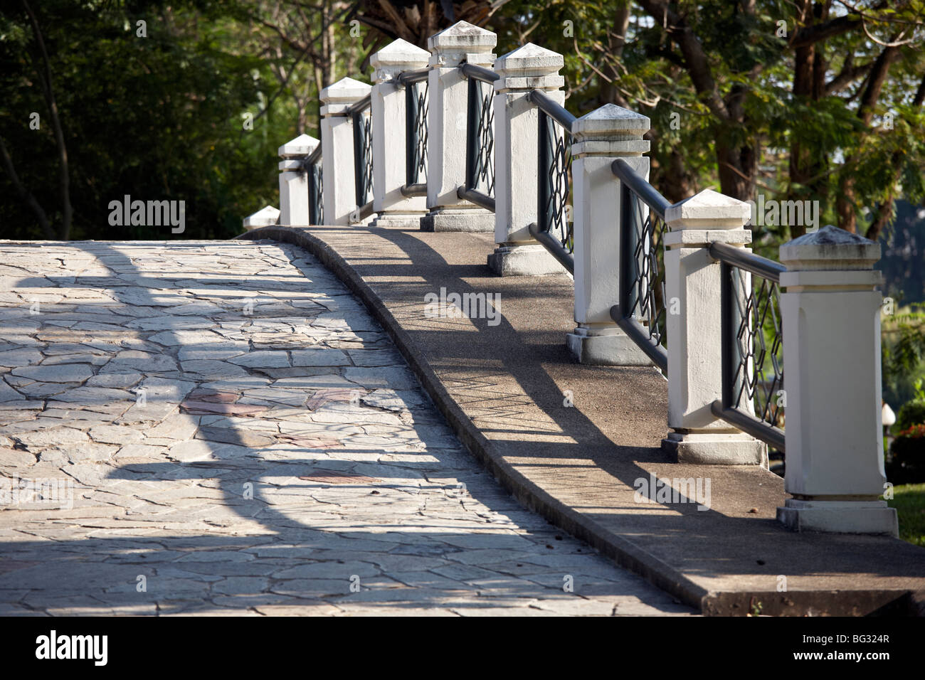 Detail and contour of a curved bridge parapet, foot walk and railings. Stock Photo