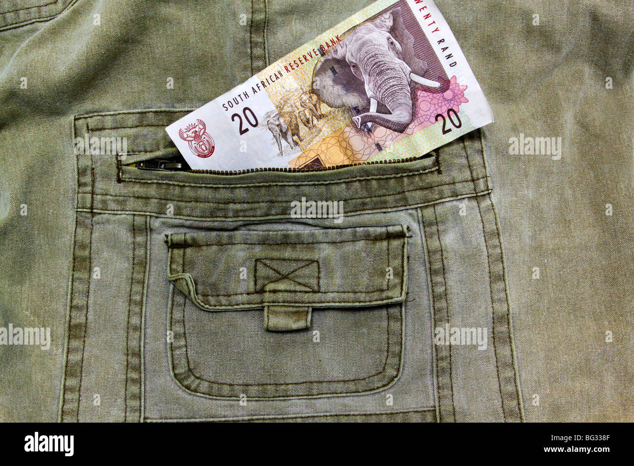South African R20 note in the pocket of a pair of khaki trousers Stock