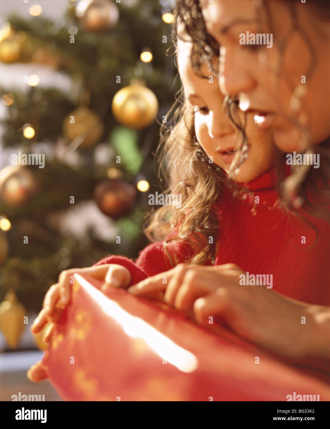 mother and daughter with christmas present Stock Photo - Alamy