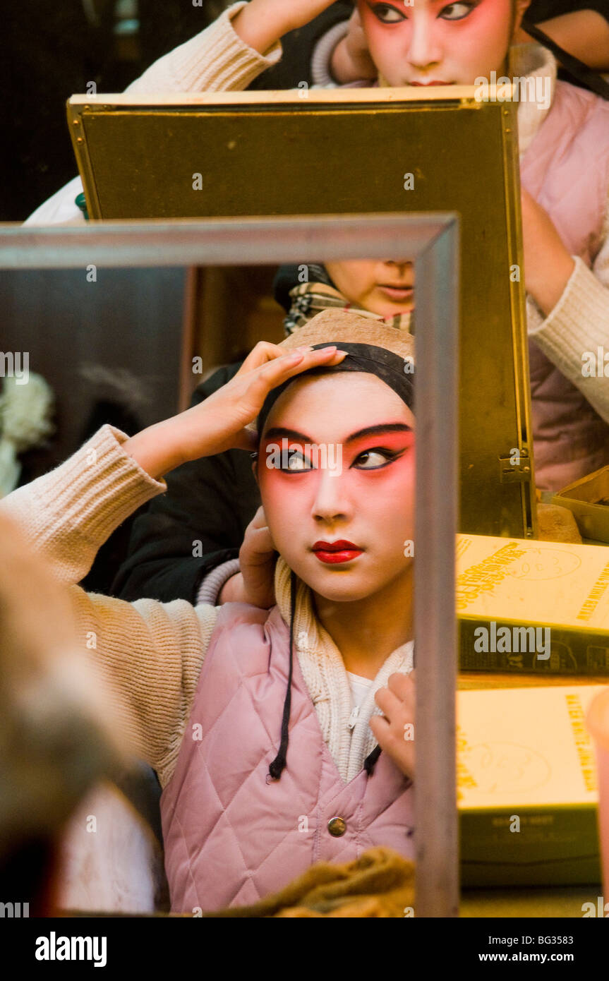 Getting ready for the opera show. A Chinese opera performer put her makeup on. Stock Photo