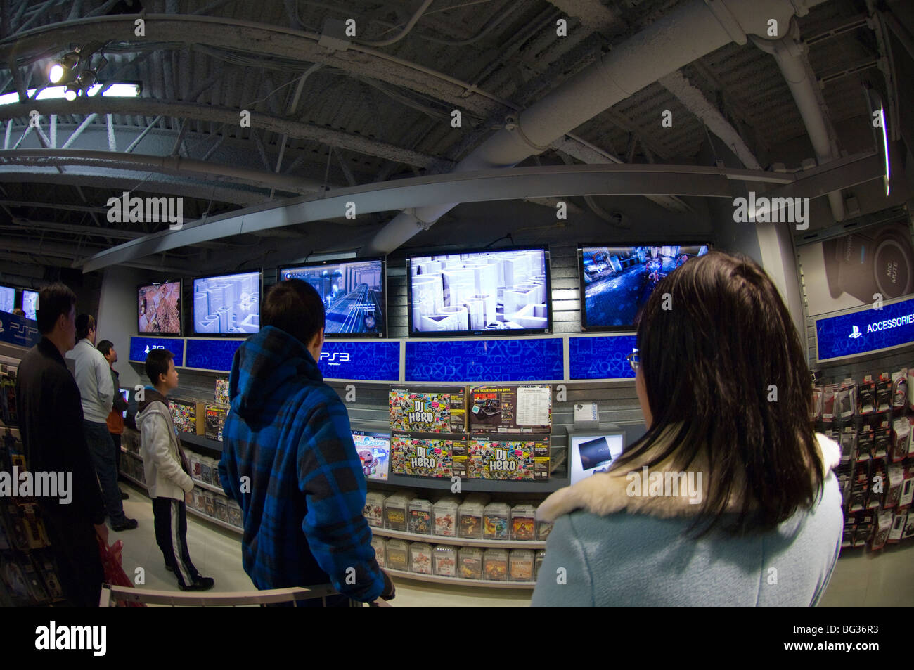Customers at a Sony Playstation display in the Times Square Toys R Us store in New York Stock Photo