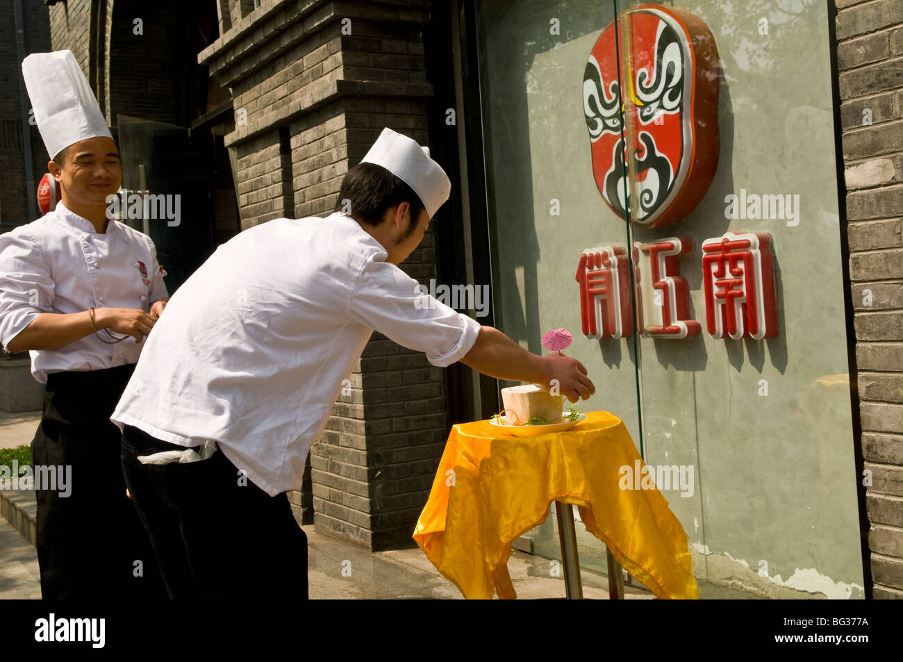 Chinese Chefs prepare the daily display outside the restaurant they work for. Stock Photo