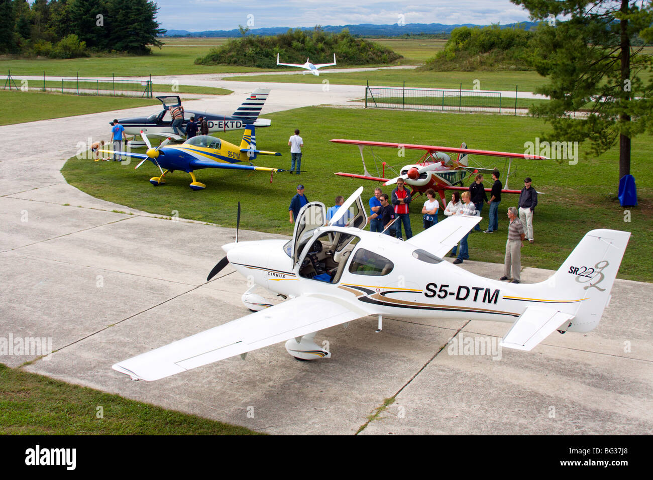 View at the small airport with few light aircrafts and spectators. Stock Photo