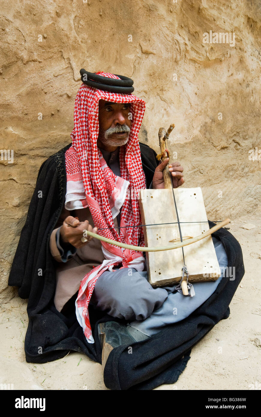 Bedouin man playing stringed instrument, Beida (Al Baidha) (Little Petra), Jordan, Middle East Stock Photo