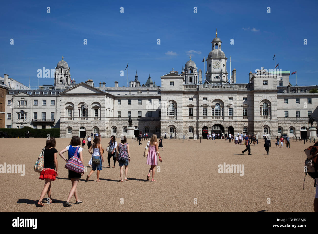 Tourists walk towards the Old Admiralty Building on Horse Guards Parade in St James', central London. Stock Photo