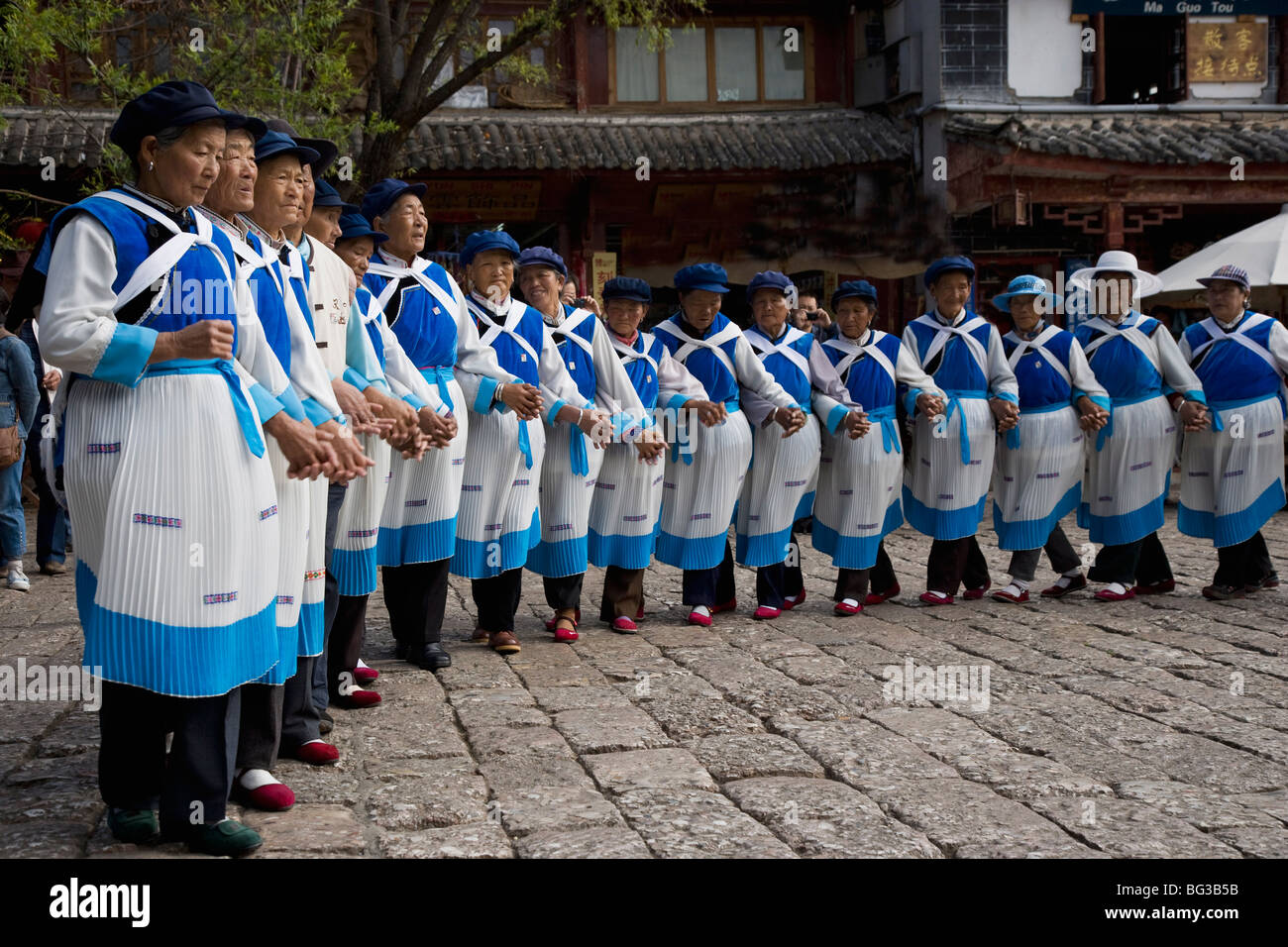 Naxi minority women dancing in Sifang Square, The Old Town, Lijiang, UNESCO World Heritage Site, Yunnan Province, China, Asia Stock Photo