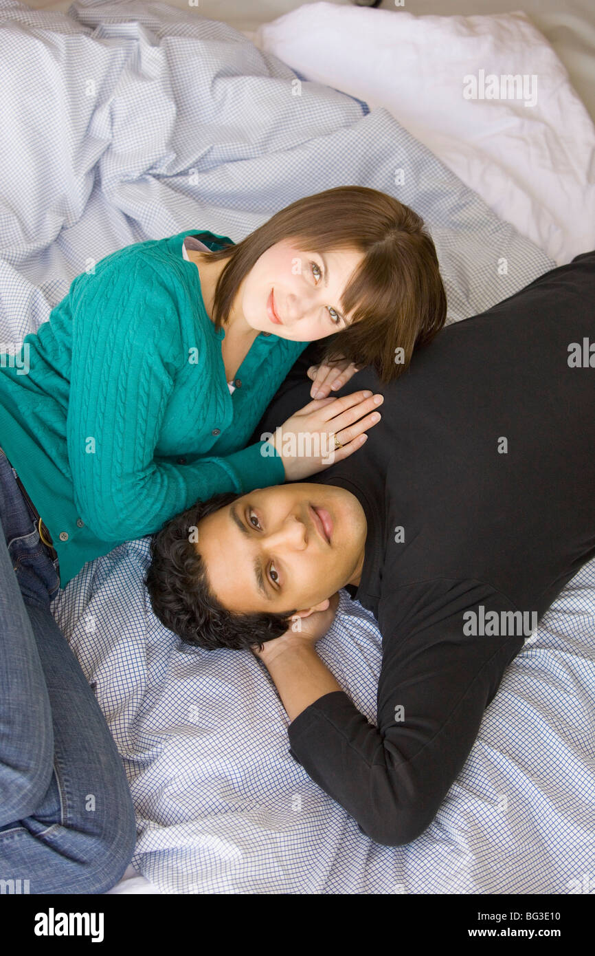 Couple lying together on bed hi-res stock photography and images - Alamy