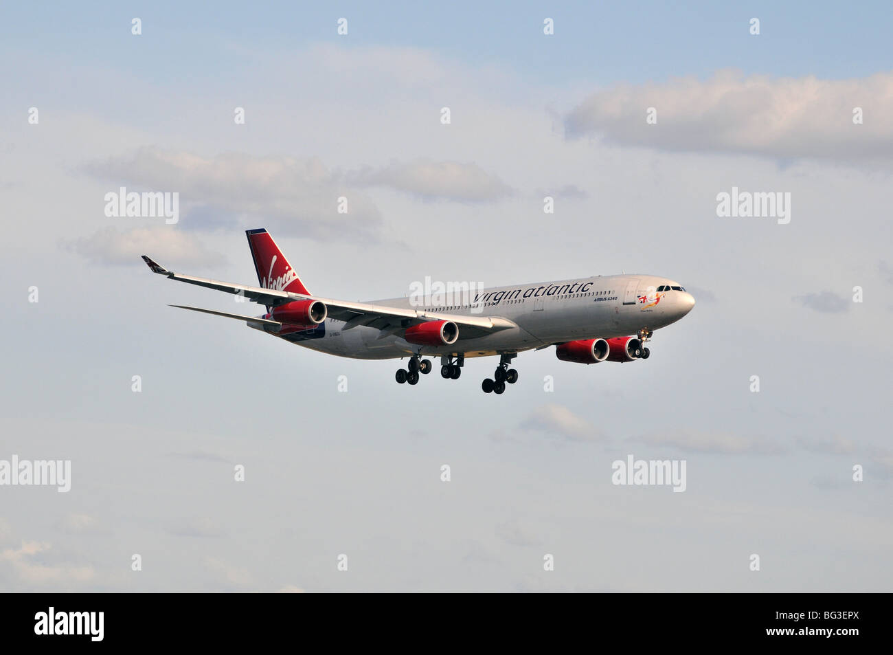 Virgin Atlantic Airbus Industries A340 G-VSEA 'Plane Sailing' on final approach to land on a summer evening Stock Photo