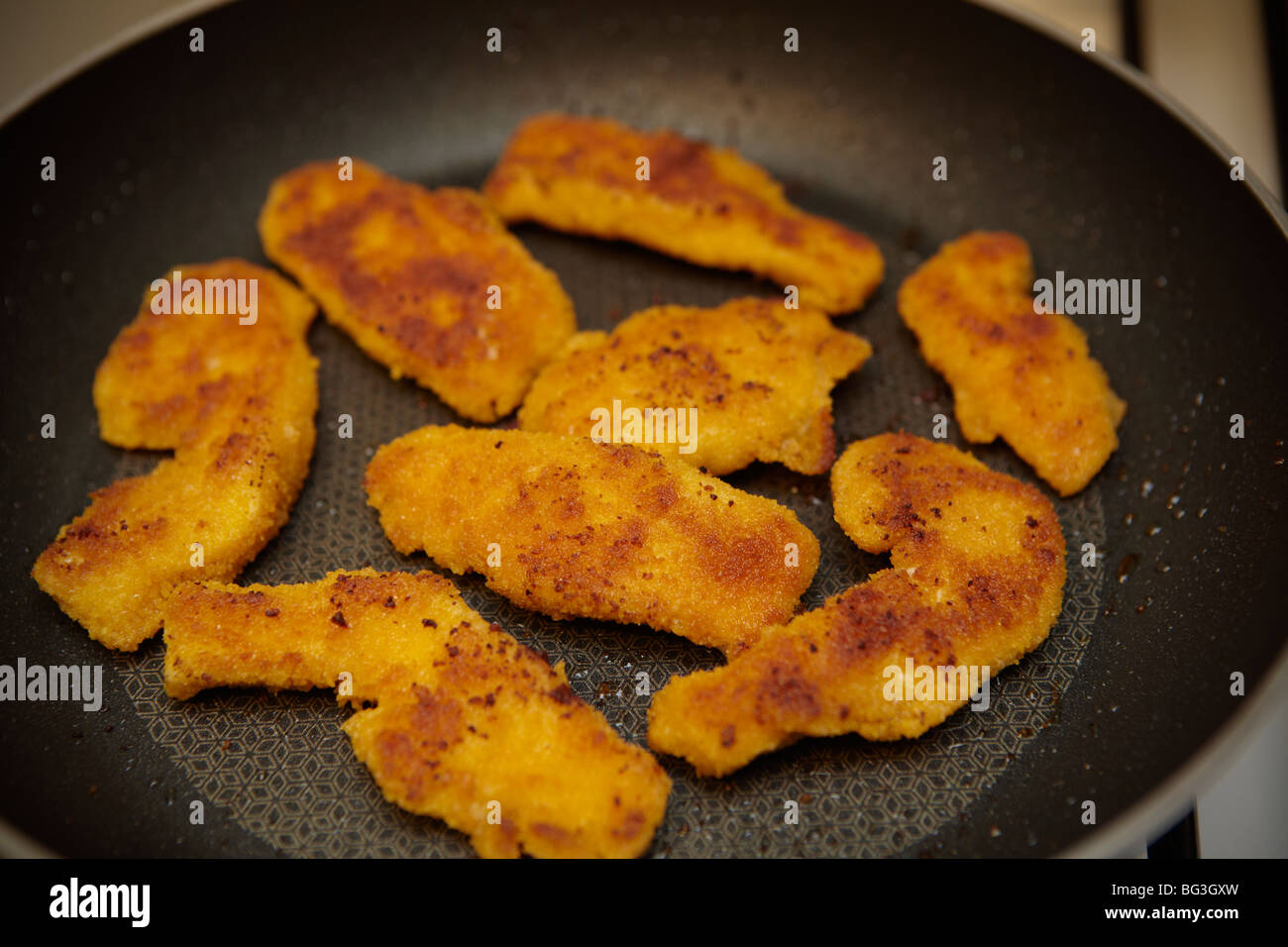 Chicken Strips Or Nuggets Being Deep-fried In A Cast-iron Frying Pan Stock  Photo, Picture and Royalty Free Image. Image 34218325.