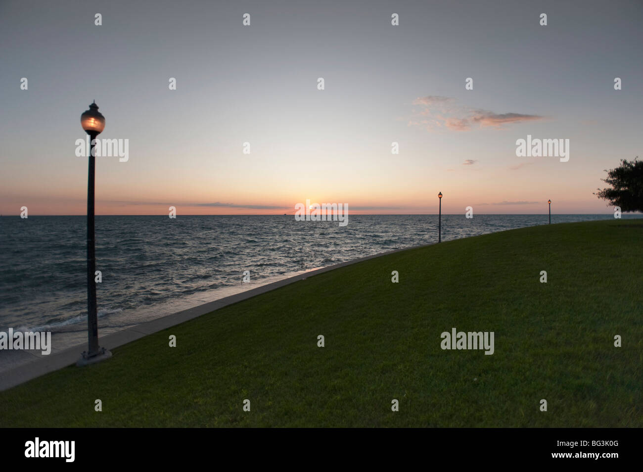 Sunset on a beach Stock Photo - Alamy