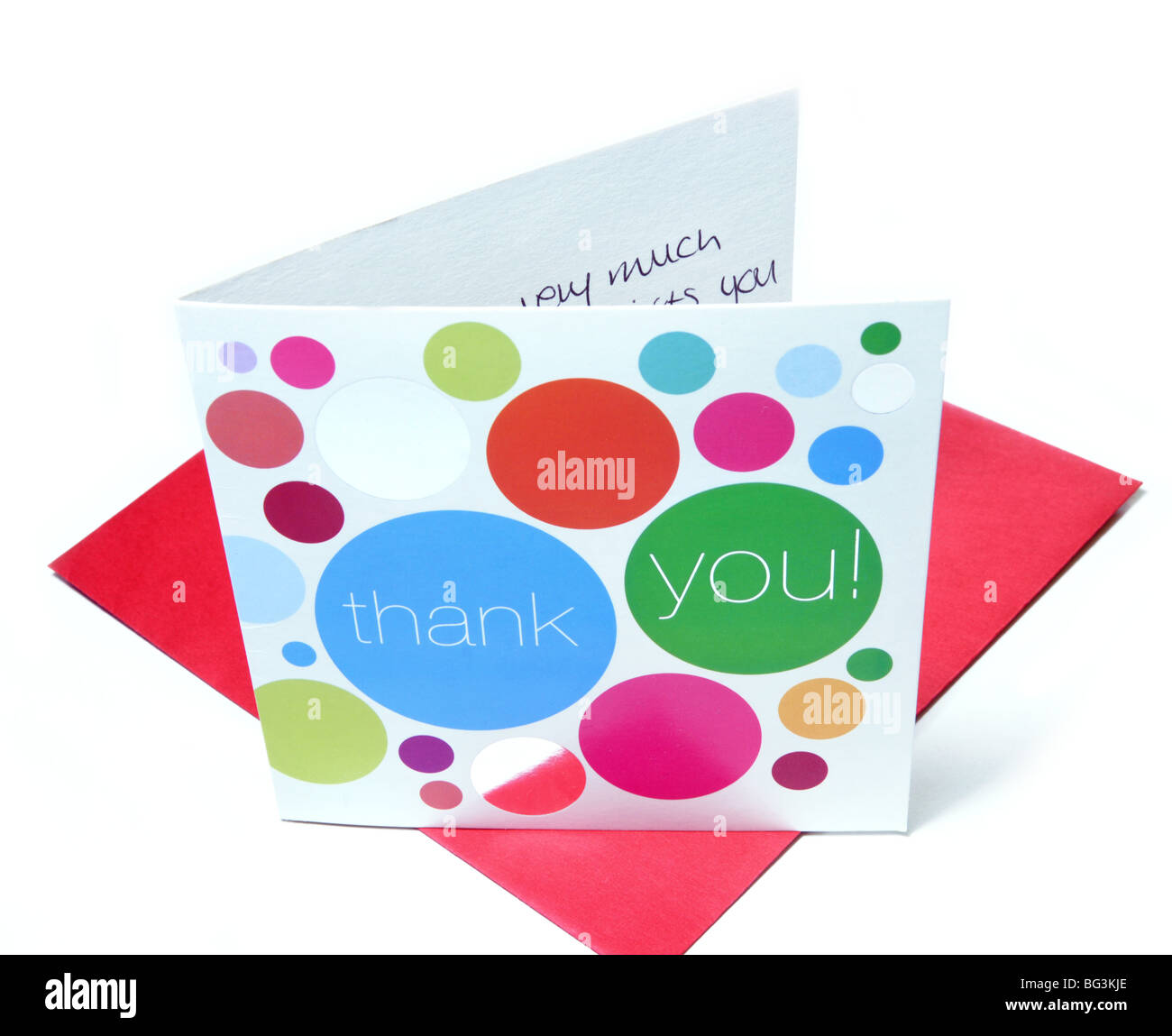 An opened thank you card stands on a red envelope. Stock Photo