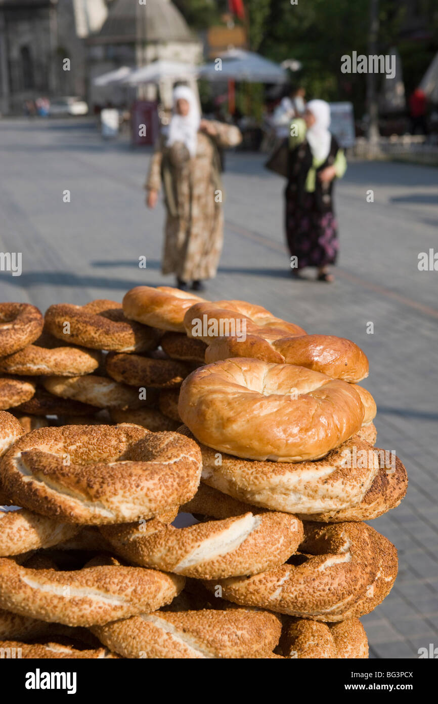Traditional Turkish bagels with sesame seeds for sale, ladies in traditional costume in distance, Istanbul, Turkey, Europe Stock Photo