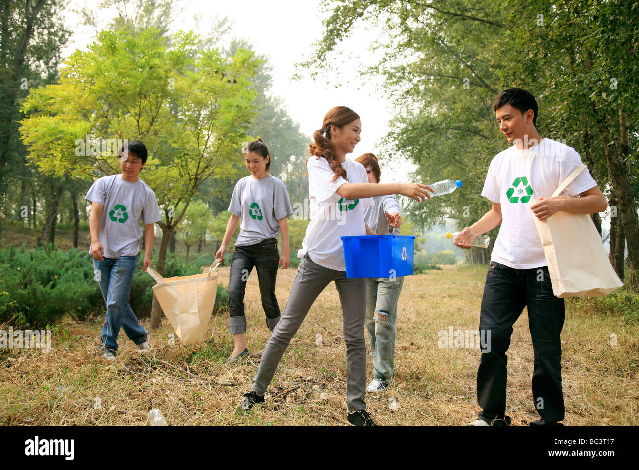young people collecting empty plastic bottles for recycling Stock Photo