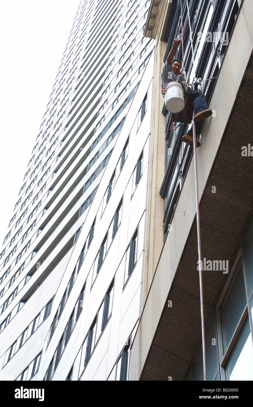 A window cleaner on a rope Stock Photo - Alamy
