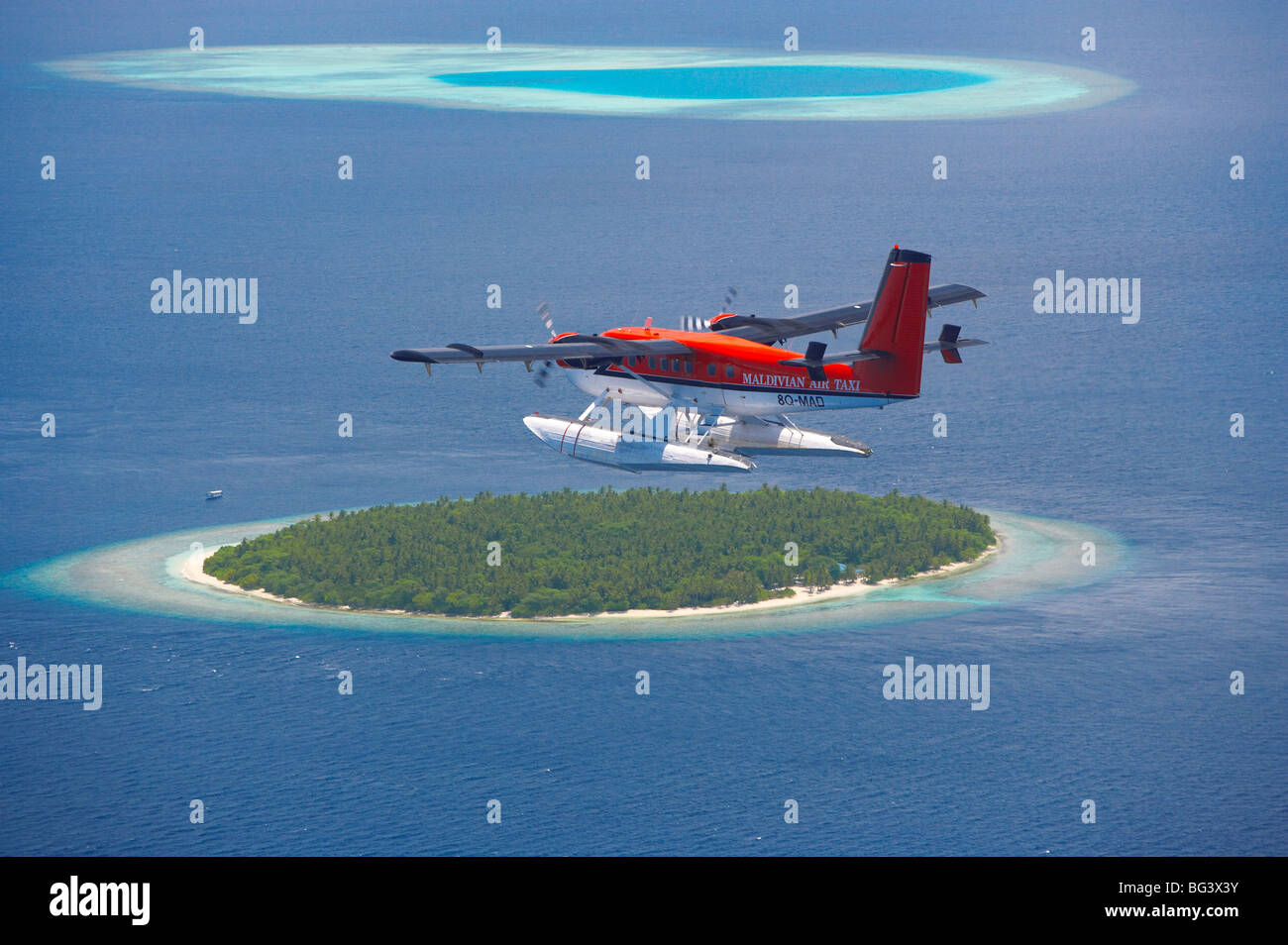 Maldivian Air Taxi flying above island, Maldives, Indian Ocean, Asia Stock Photo