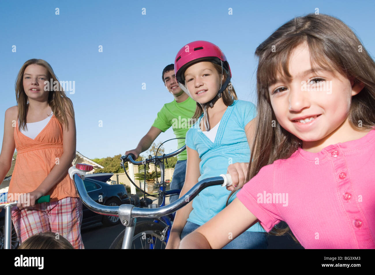 Children with scooters and bicycle Stock Photo