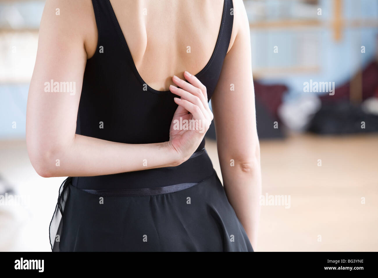 Young woman stretches in ballet rehearsal Stock Photo