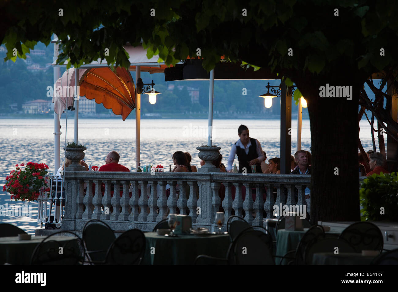 Italy, Lombardy, Lakes Region, Lake Como, Bellagio, lakeside cafe, dusk, NR Stock Photo