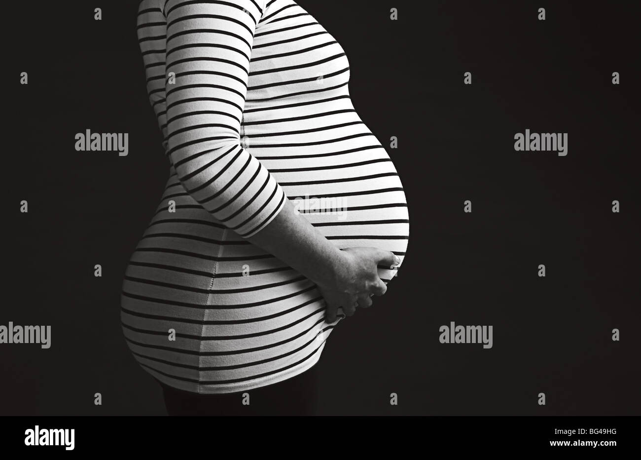 Low Key Shot of a Pregnant Woman Stock Photo
