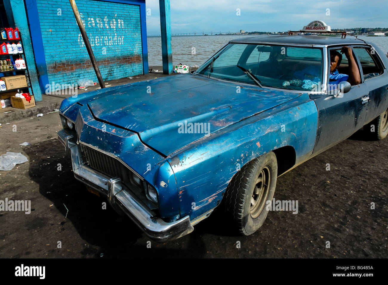 A scratched American classic car from 1970s, used as a shared taxi, waiting on the stand in Maracaibo, Venezuela. Stock Photo