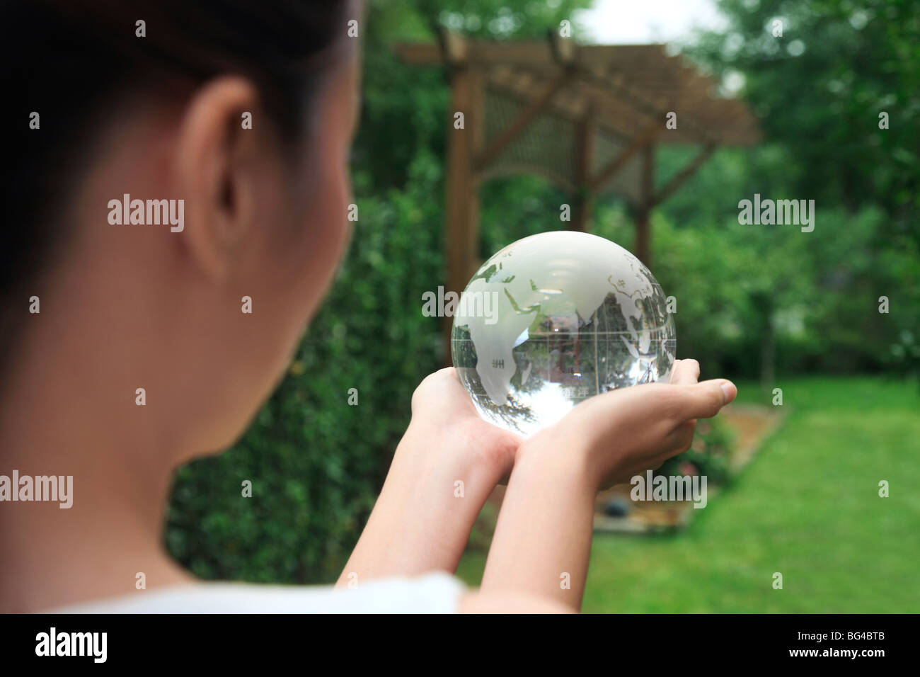 young woman holding crystal ball Stock Photo - Alamy