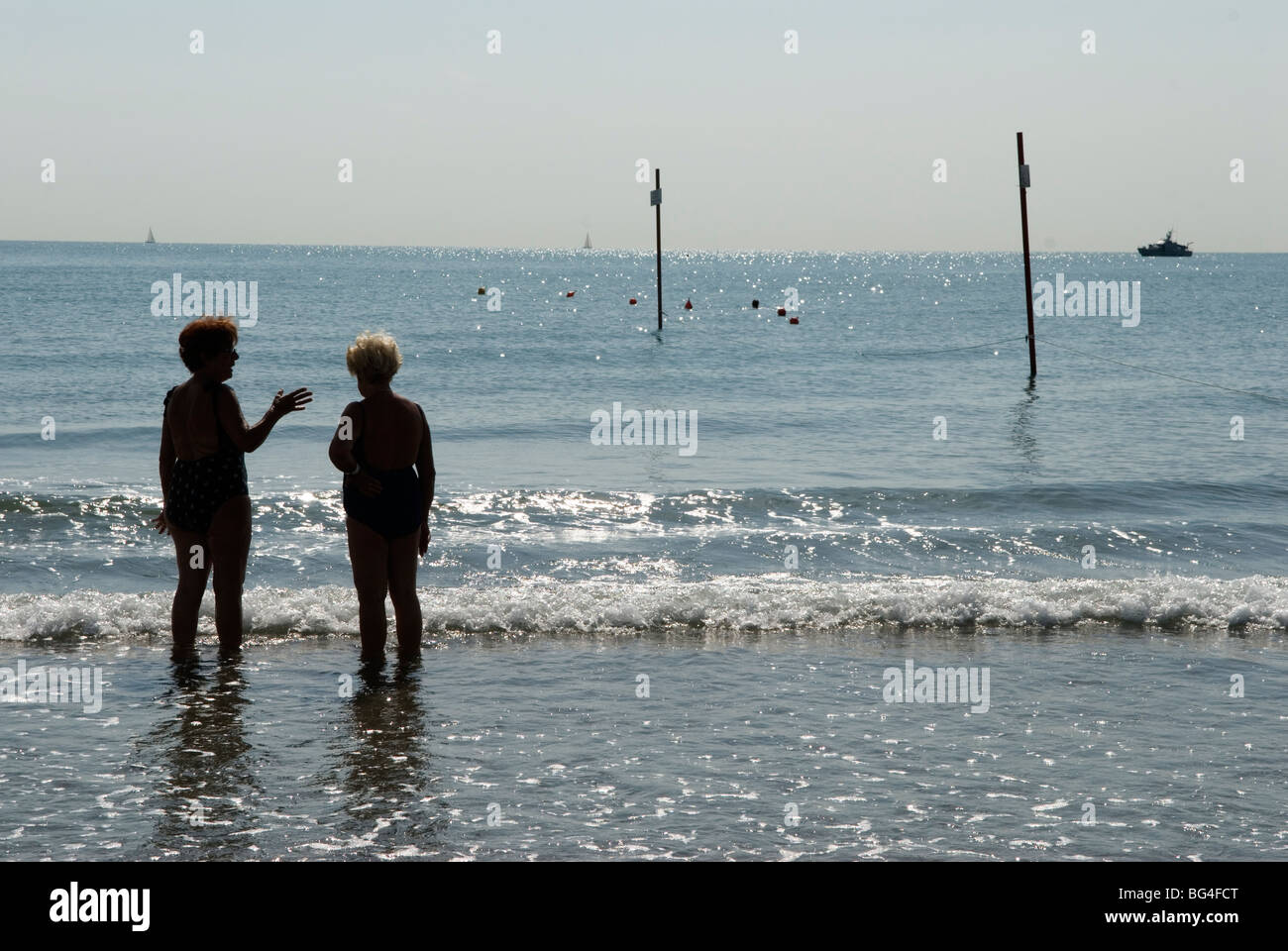 Venice Lido Adriatic sea the public beach. Two older woman chatting alone in the sea, on holiday. Venice Italy  2000s 2009 HOMER SYKES Stock Photo