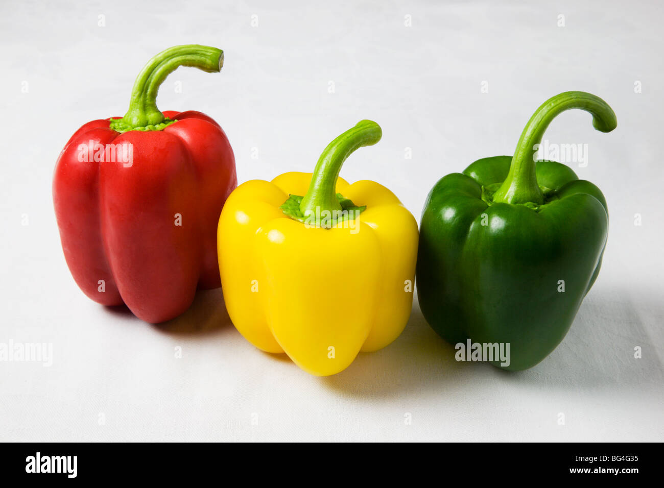 Red Yellow and Green Peppers on a White Background Stock Photo - Alamy