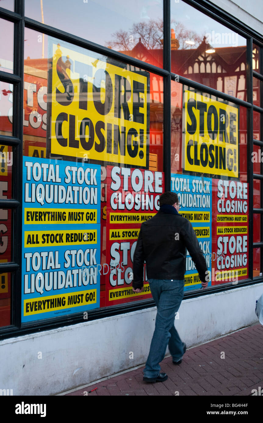 shop window signs notifying store closing down and stock liquidation in