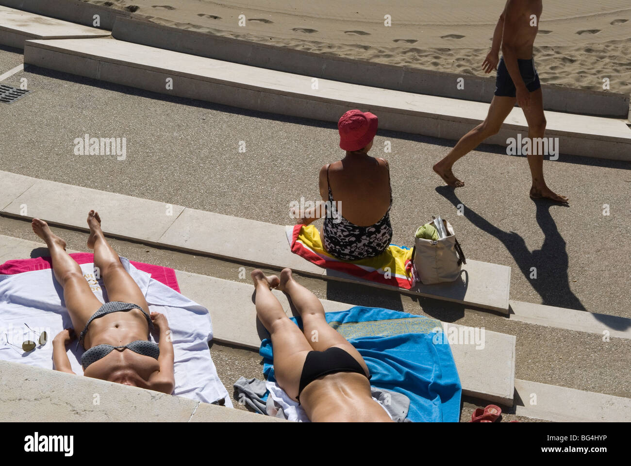Venice Lido beach Italy. Young Italian women wearing bikini getting a suntan sunbathing, relaxing on holiday. 2000s 2009 HOMER SYKES Stock Photo